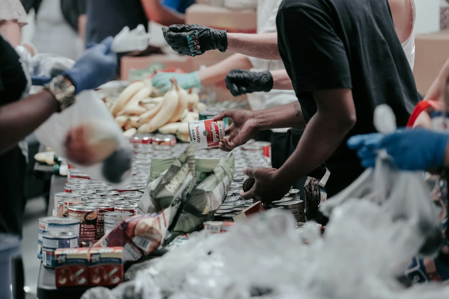 Volunteers sorting canned goods at a community food drive
